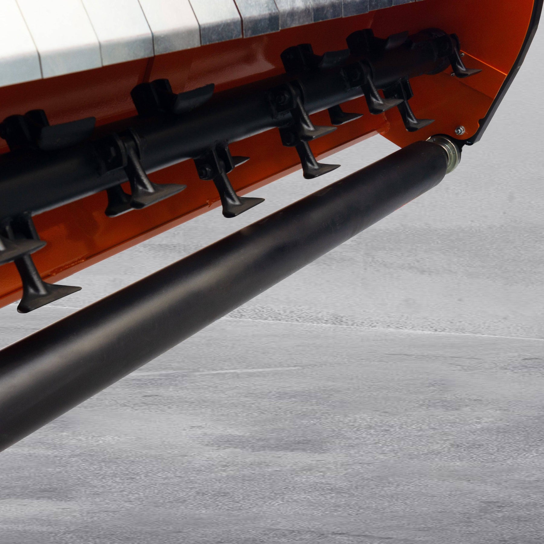 Close-up of the underside of the farmry 3 Point 53 Flail Mower (LFS53), a PTO-powered attachment for 15-35HP Category 1 tractors, showing its rotating blades and cylindrical roller on concrete.