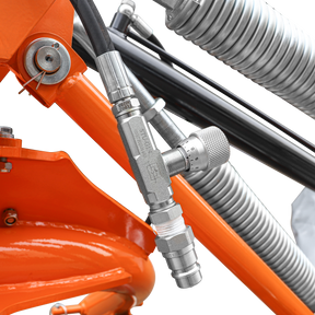 Close-up of a metallic valve with black hoses on a Farmry 3 Point 81" Disc Mower (DHM7, 5 Discs, PTO Powered, 35–80HP) for Category 1 & 2 tractors, mounted on an orange frame with coiled springs in the background.