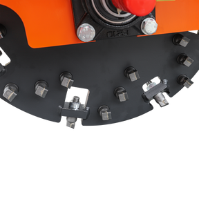 Close-up of the Farmry SG24 Pro 3-Point PTO Stump Grinder, showing its circular blade with 34 carbide teeth and multiple bolts, attached to an orange machine part with a PTO shaft. Features include two torsion springs and a speed indicator. White background.